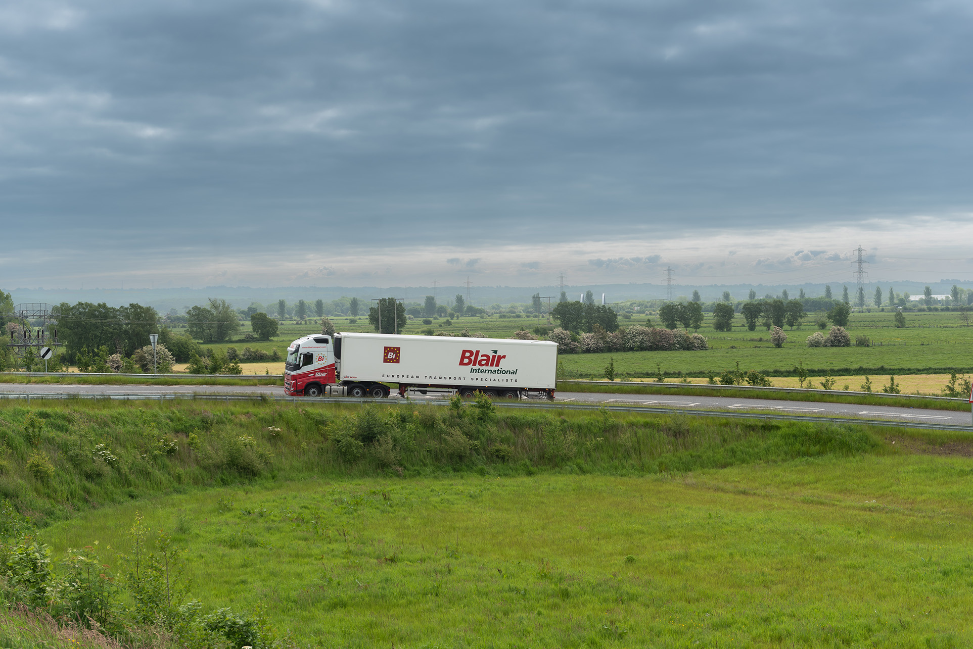 Blair International Transport Truck and Trailer Driving on a Scenic Road